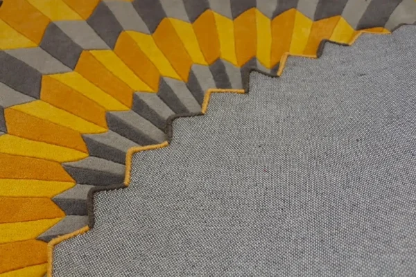 Close up to Annika Johansson's art painting "Rosette NY" as handmade rug in yellow and grey. Unique shape round rug.